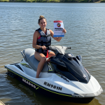ALL - woman on jetski holding certificate 2